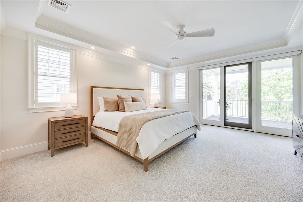 66 Simons Road, Unit C Mashpee, MA 02649 - Photo 18 of 42 a bed sitting in a spacious bedroom next to a window