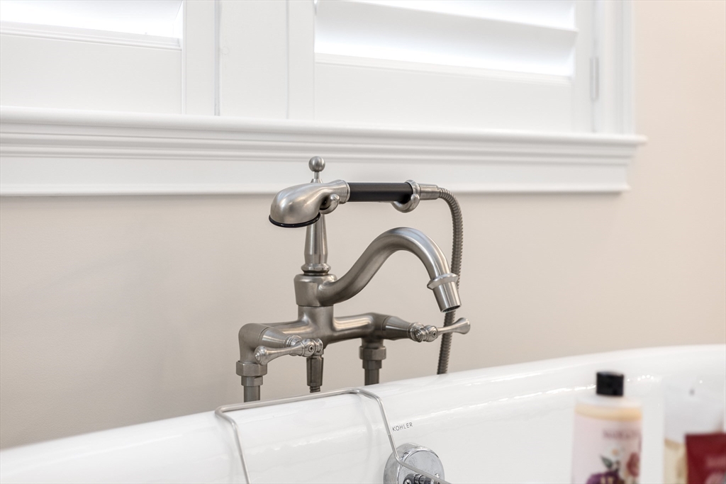 66 Simons Road, Unit C Mashpee, MA 02649 - Photo 20 of 42 a bathroom with a sink and mirror