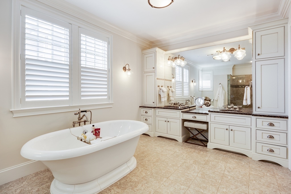 66 Simons Road, Unit C Mashpee, MA 02649 - Photo 22 of 42 a white bath tub sitting next to a bathroom sink and a window