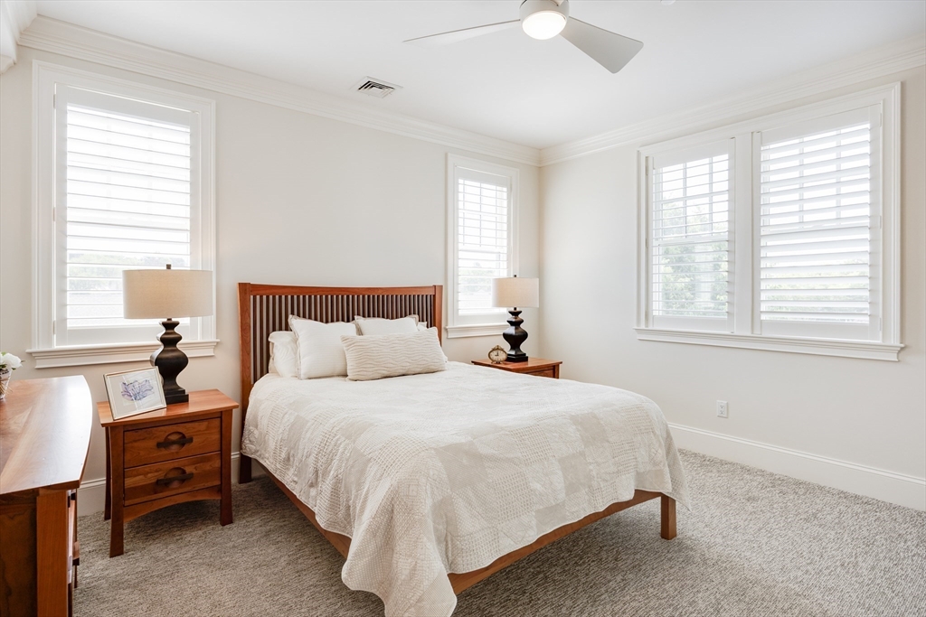 66 Simons Road, Unit C Mashpee, MA 02649 - Photo 24 of 42 a bedroom with a bed and a window