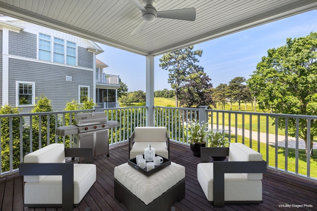 66 Simons Road, Unit C Mashpee, MA 02649 - Photo 29 of 42 a view of a patio with couches chairs and wooden floor