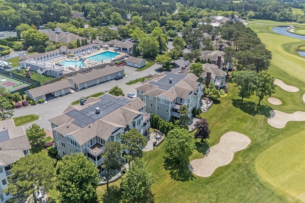 66 Simons Road, Unit C Mashpee, MA 02649 - Photo 33 of 42 an aerial view of a house with a swimming pool yard and mountain view in back