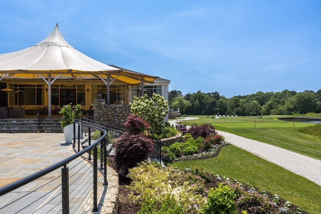 66 Simons Road, Unit C Mashpee, MA 02649 - Photo 38 of 42 a front view of a house with garden