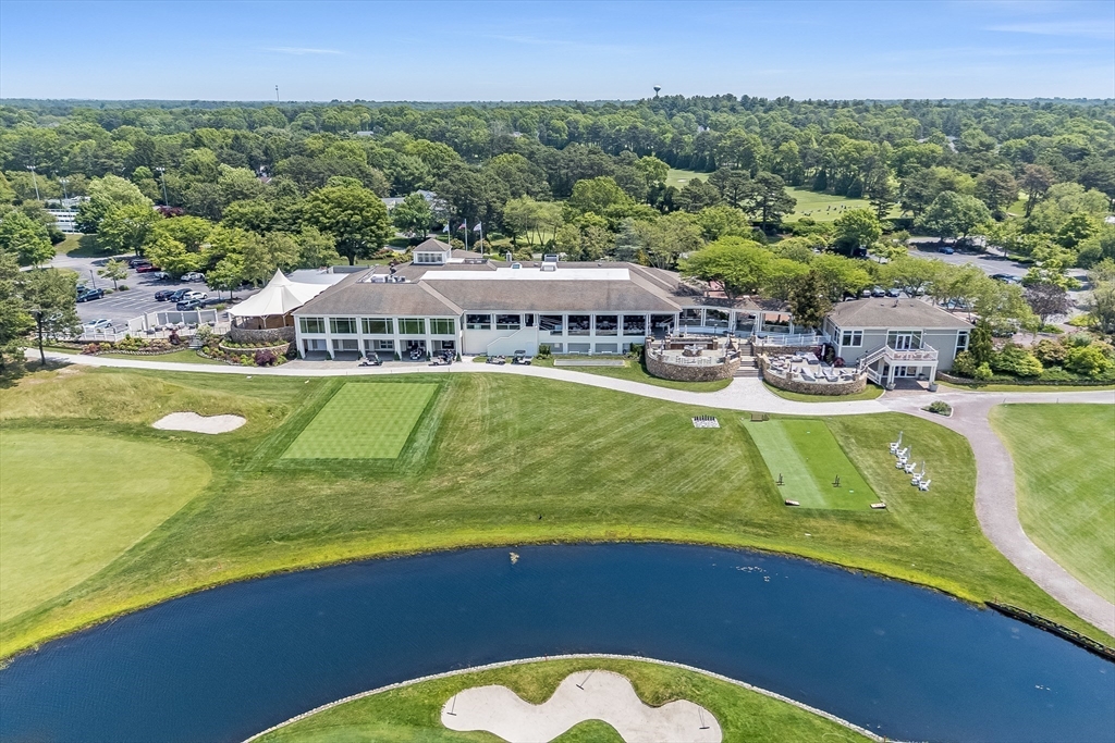 66 Simons Road, Unit C Mashpee, MA 02649 - Photo 40 of 42 a view of a swimming pool with outdoor seating and yard