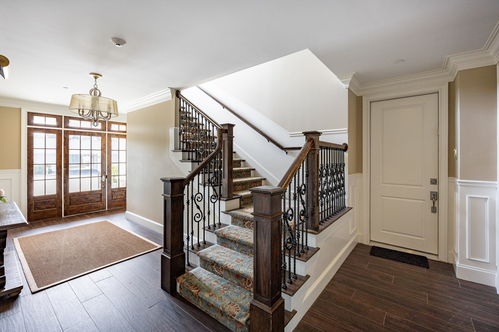 66 Simons Road, Unit C Mashpee, MA 02649 - Photo 4 of 42 a view of front door with hallway and wooden floor