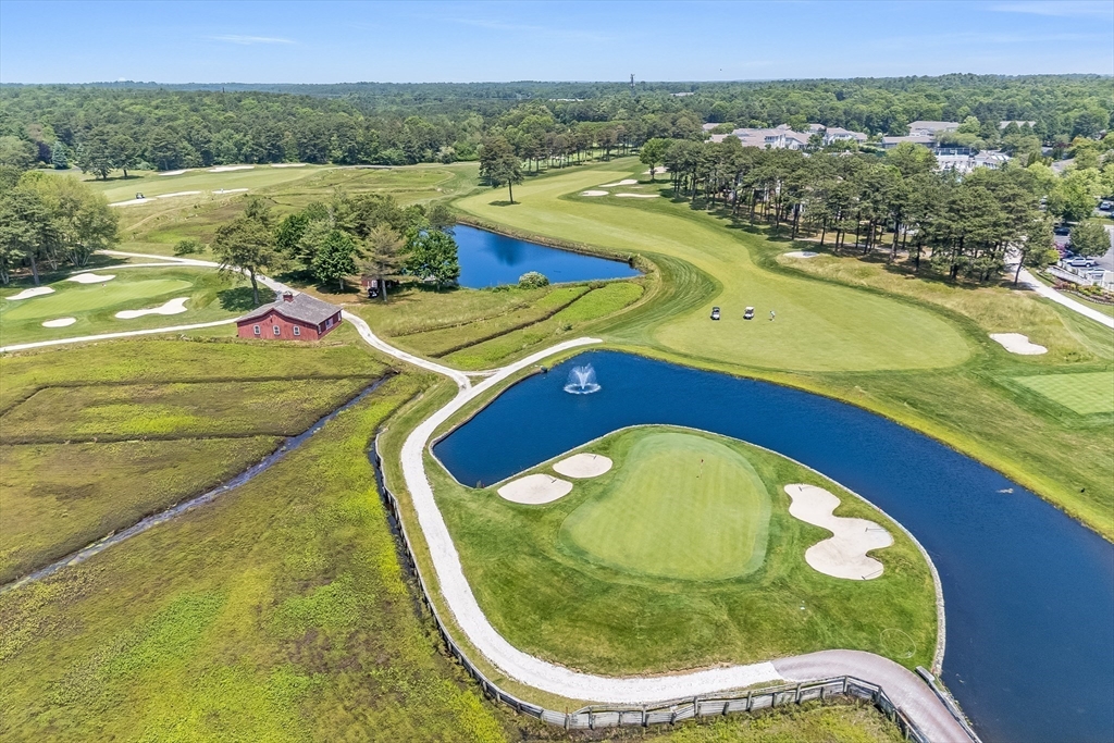 66 Simons Road, Unit C Mashpee, MA 02649 - Photo 41 of 42 a view of a swimming pool with a garden