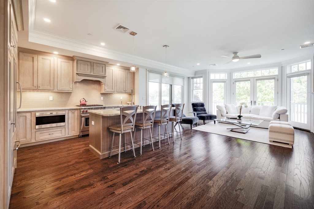 66 Simons Road, Unit C Mashpee, MA 02649 - Photo 6 of 42 a kitchen with lots of counter top space and living room