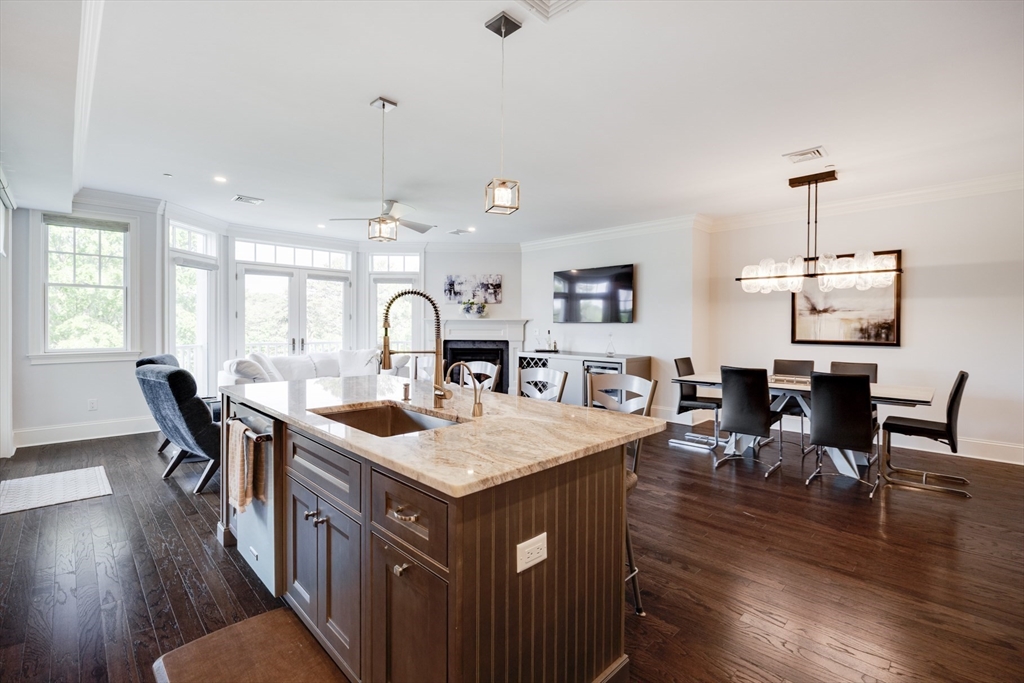 66 Simons Road, Unit C Mashpee, MA 02649 - Photo 7 of 42 a kitchen with a table chairs and wooden floor