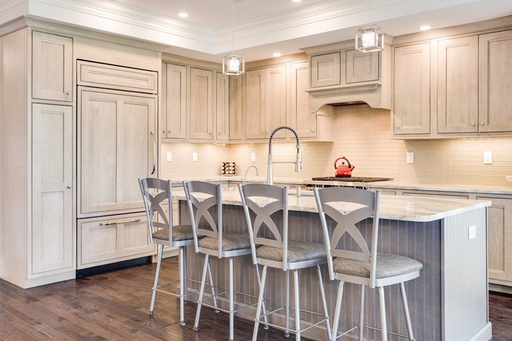 66 Simons Road, Unit C Mashpee, MA 02649 - Photo 8 of 42 a kitchen with a table and chairs