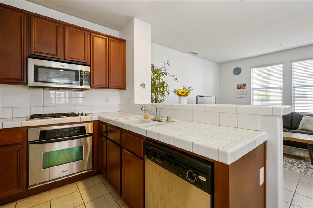 106 Tiger Lane Placentia, CA 92870 - Photo 12 of 35 a kitchen with a sink stove and microwave