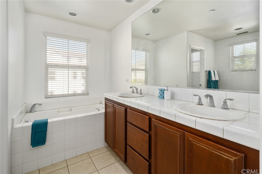 106 Tiger Lane Placentia, CA 92870 - Photo 21 of 35 a bathroom with a granite countertop sink mirror bathtub and double