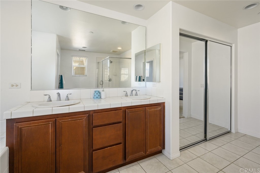 106 Tiger Lane Placentia, CA 92870 - Photo 23 of 35 a bathroom with a double vanity sink and a mirror