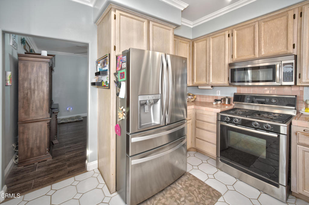1112 Mockingbird Lane Fillmore, CA 93015 - Photo 6 of 21 a kitchen with stainless steel appliances granite countertop a refrigerator and a stove top oven