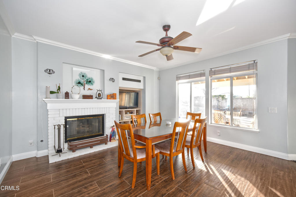 1112 Mockingbird Lane Fillmore, CA 93015 - Photo 8 of 21 a dining room with furniture a fireplace and wooden floor