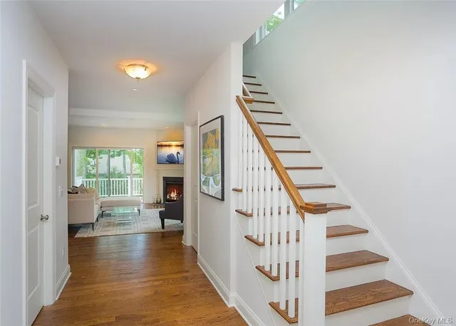 a view of entryway and hall with wooden floor