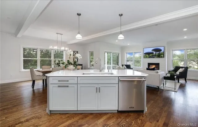 a kitchen with stainless steel appliances granite countertop a sink stove and wooden floor