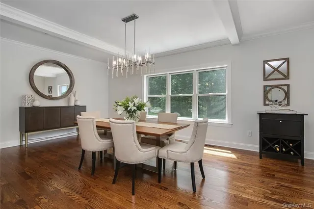 a dining room with furniture a chandelier and wooden floor