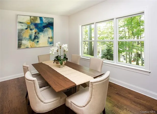 a dining room with furniture and wooden floor