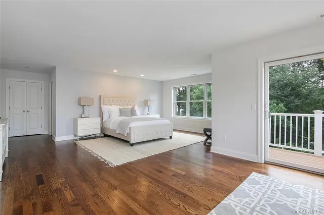 a spacious bedroom with a bed and a large window