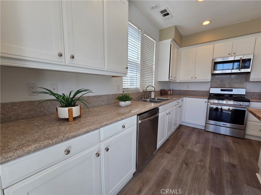 20329 Red Poppy Lane Riverside, CA 92508 - Photo 11 of 24 a kitchen with stainless steel appliances granite countertop a sink a stove and cabinets