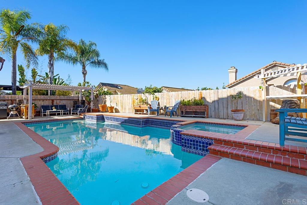 a view of a swimming pool with a table and chairs