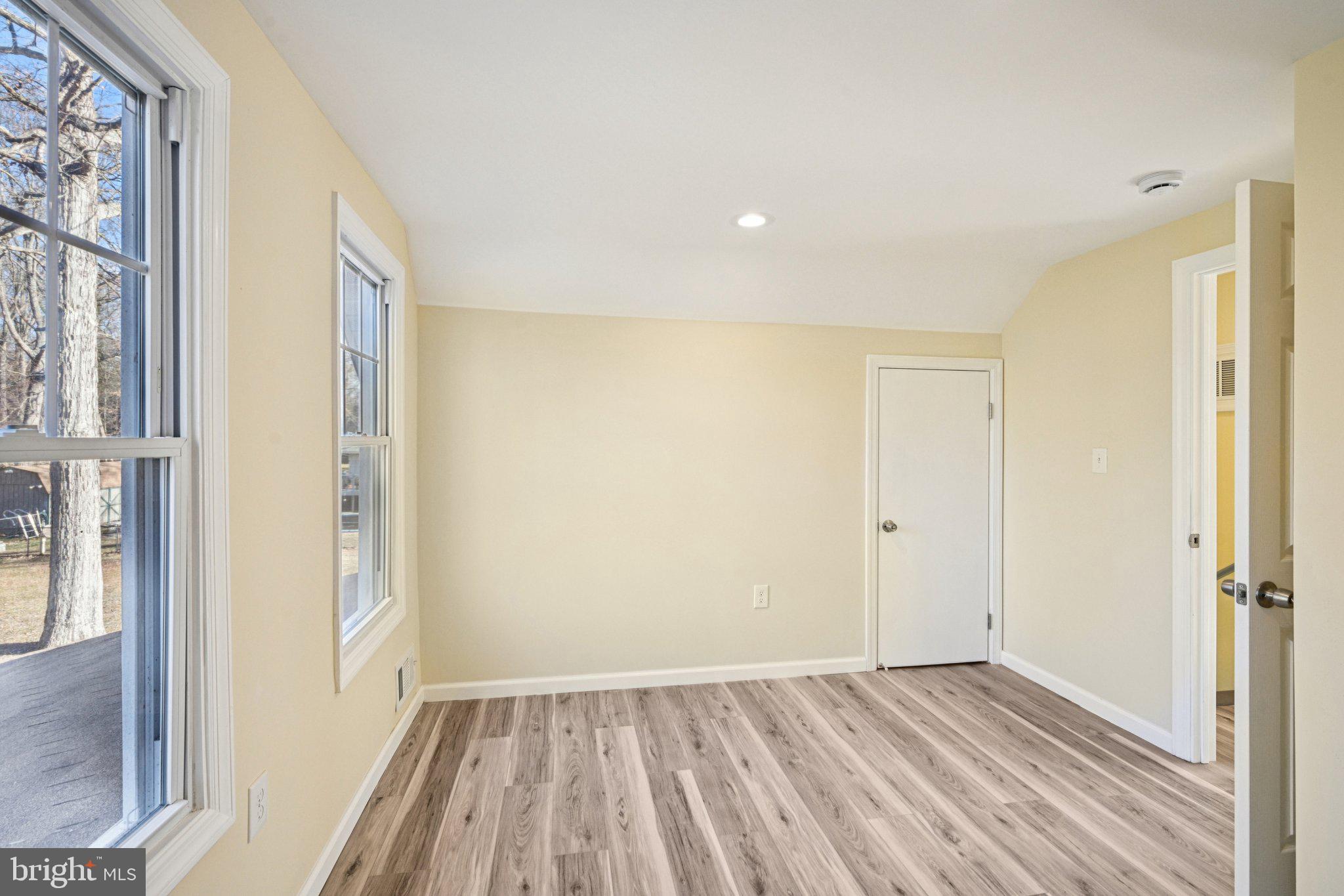 195 Chews Landing Road Clementon, NJ 08021 - Photo 23 of 48 a view of an empty room with wooden floor and a window