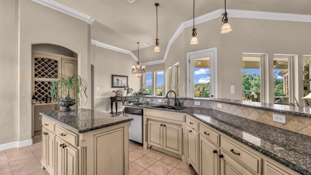840 Hensley Road Gordon, TX 76453 - Photo 16 of 40 Kitchen featuring light tile patterned flooring, cream cabinetry, a sink, dishwasher, and decorative light fixtures