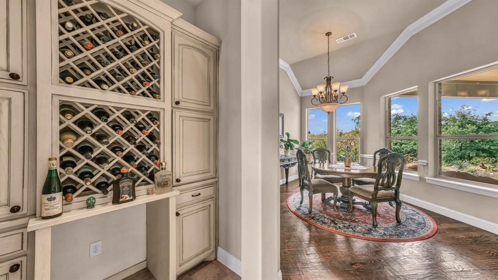 840 Hensley Road Gordon, TX 76453 - Photo 18 of 40 Wine cellar featuring a chandelier, visible vents, crown molding, baseboards, and lofted ceiling