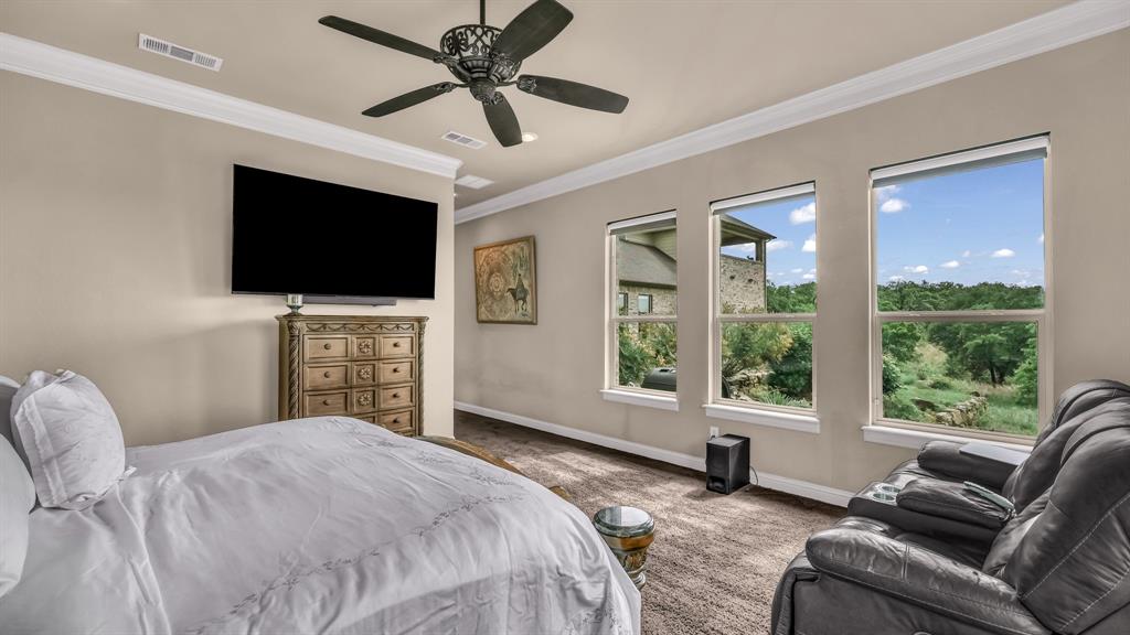 840 Hensley Road Gordon, TX 76453 - Photo 23 of 40 Carpeted bedroom featuring crown molding, baseboards, a ceiling fan, and visible vents