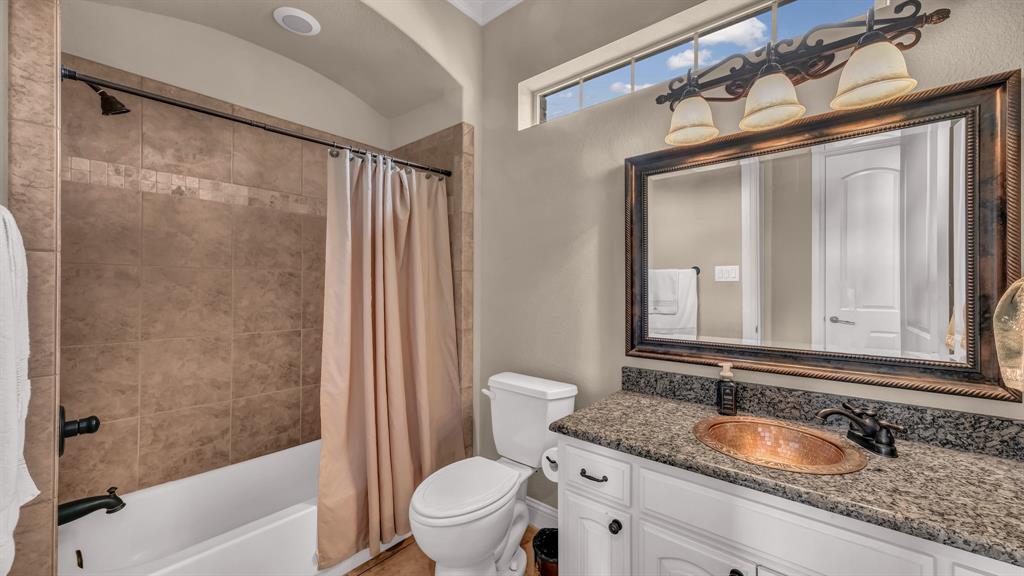 840 Hensley Road Gordon, TX 76453 - Photo 29 of 40 Full bathroom with vanity, shower / bathtub combination with curtain, and toilet