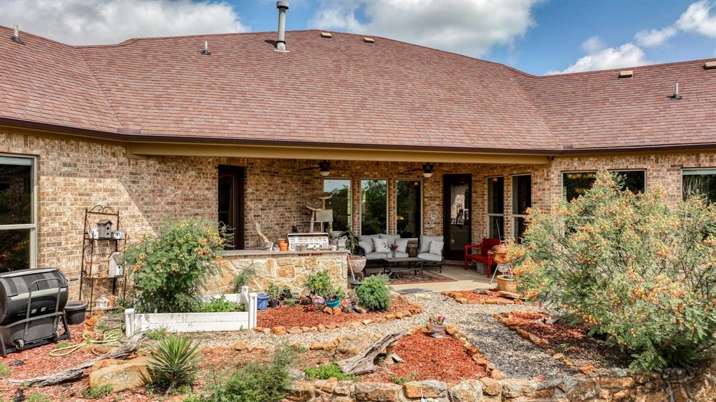 840 Hensley Road Gordon, TX 76453 - Photo 36 of 40 Rear view of property featuring an outdoor hangout area, a patio, ceiling fan, and brick siding