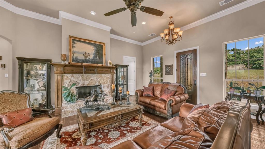 840 Hensley Road Gordon, TX 76453 - Photo 10 of 40 Living room with a ceiling fan, visible vents, a high end fireplace, wood finished floors, and recessed lighting