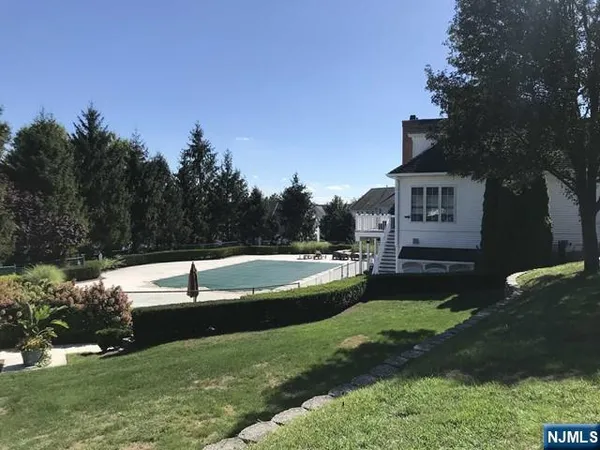 a view of a house with a yard and a swimming pool