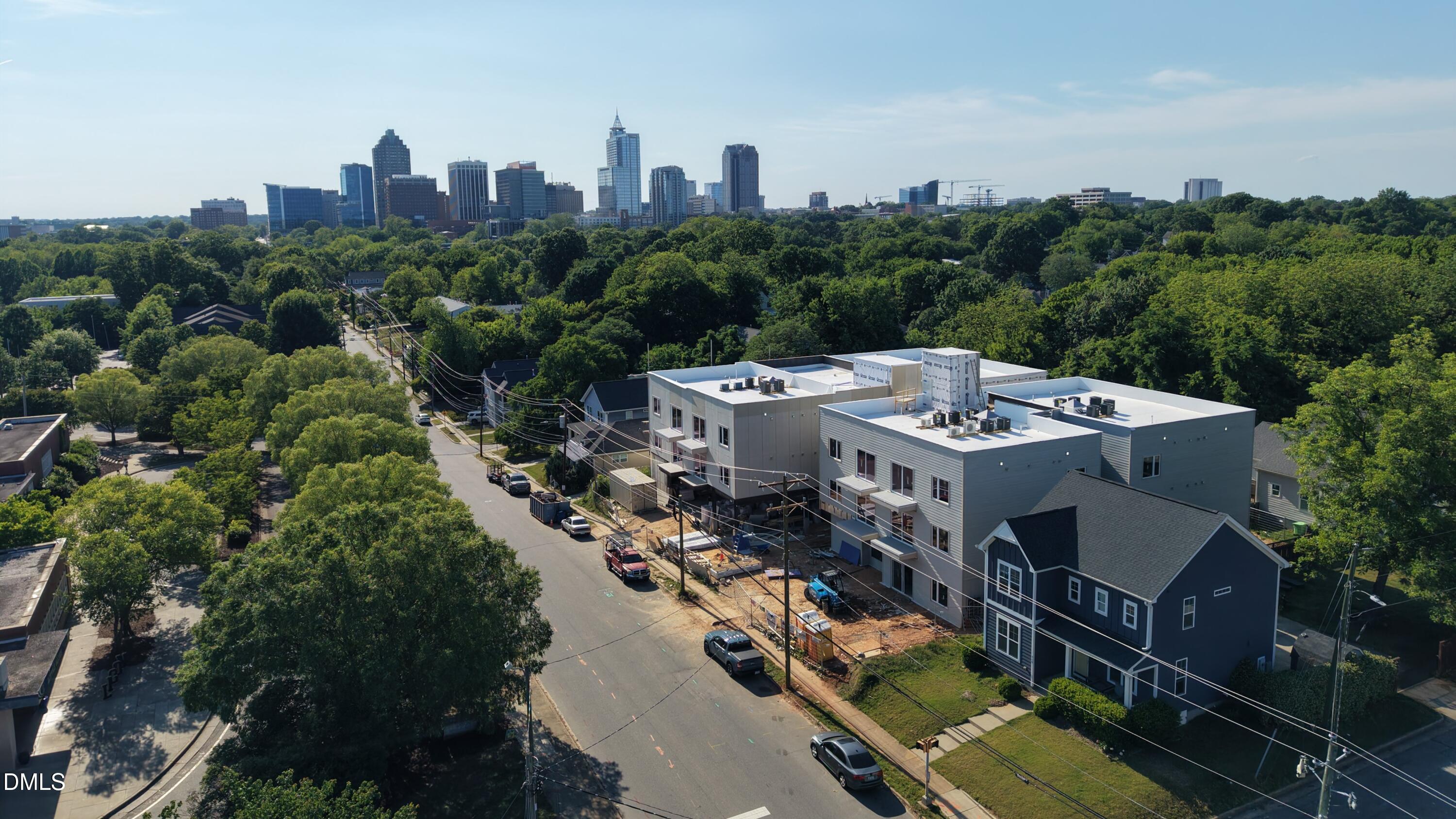 an aerial view of a house with roof deck and city view