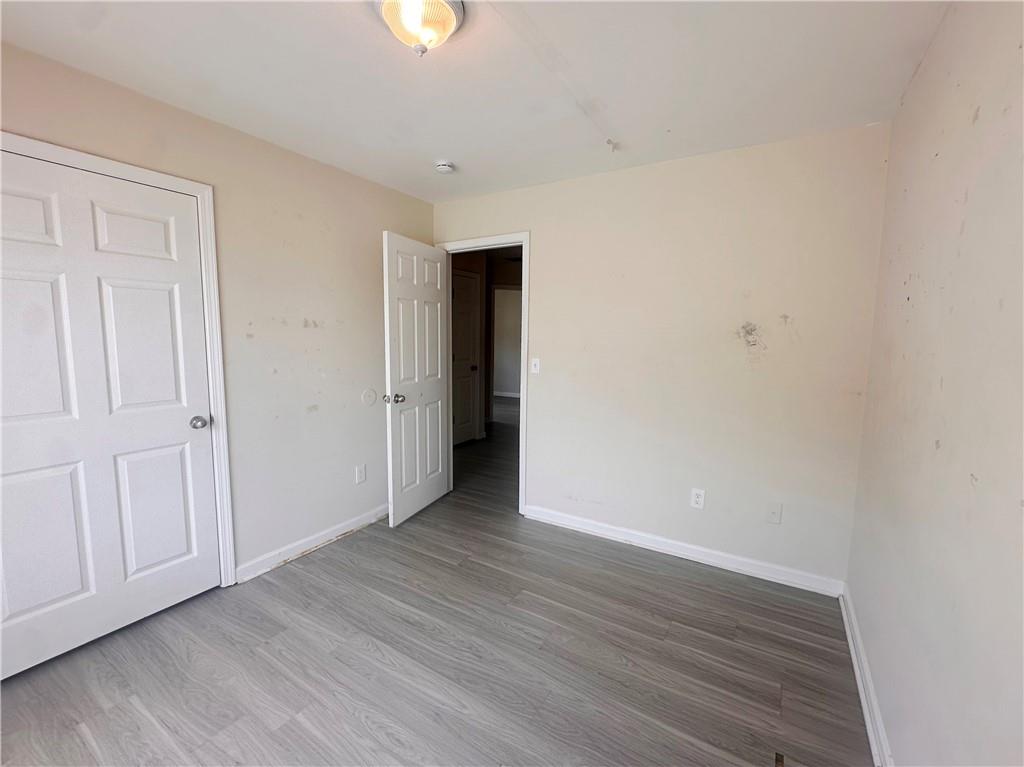 838 Store House Court, Unit A Monroe, GA 30655 - Photo 13 of 22 a view of an empty room with wooden floor