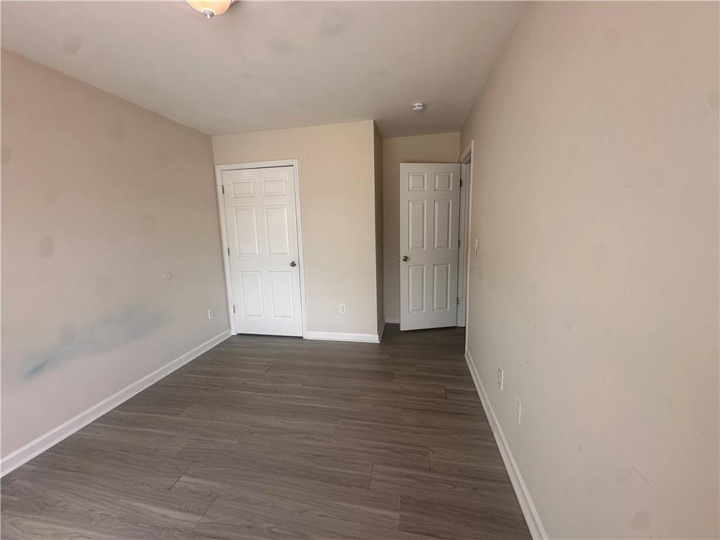 838 Store House Court, Unit A Monroe, GA 30655 - Photo 16 of 22 a view of an empty room with wooden floor