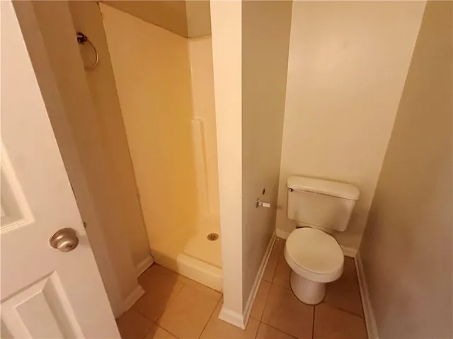 a bathroom with a toilet and a shower