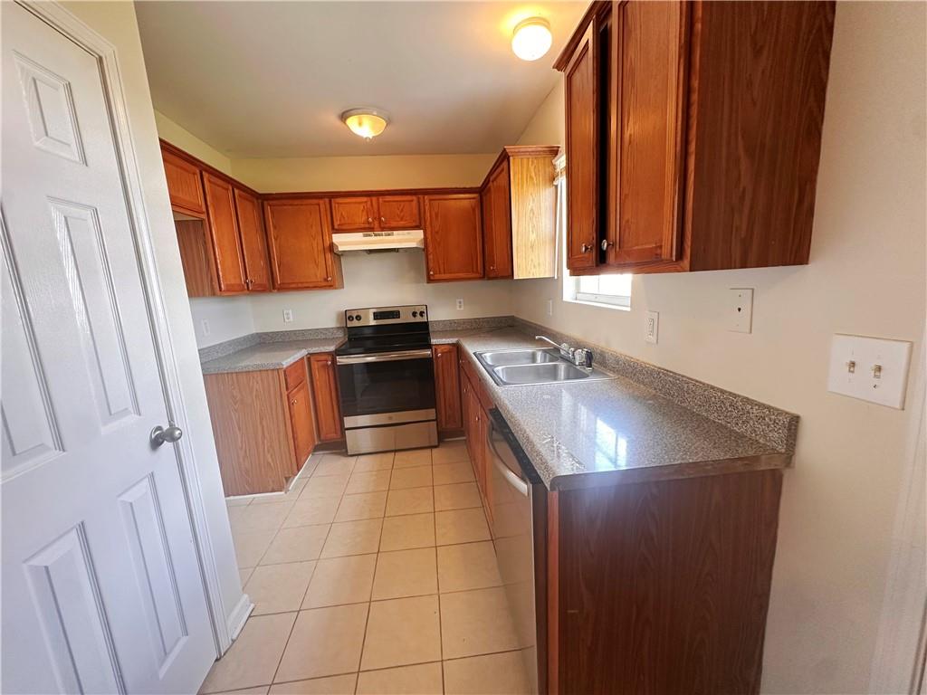 838 Store House Court, Unit A Monroe, GA 30655 - Photo 10 of 22 a kitchen with stainless steel appliances granite countertop a sink stove and refrigerator