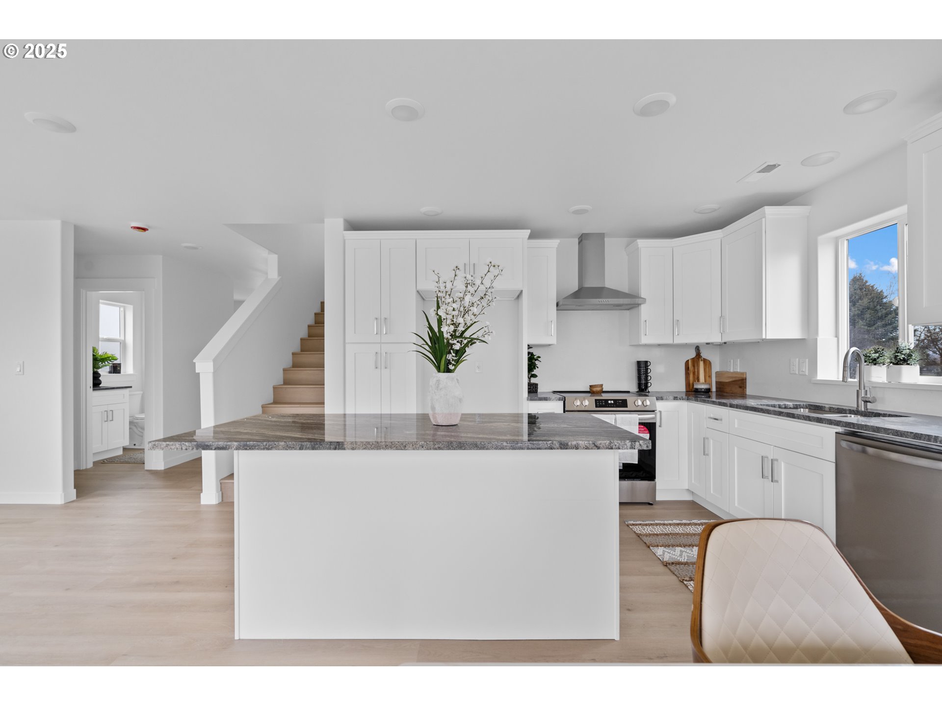 360 Southeast 4th Street Irrigon, OR 97844 - Photo 18 of 36 a kitchen with stainless steel appliances kitchen island a white counter top space a sink and cabinets