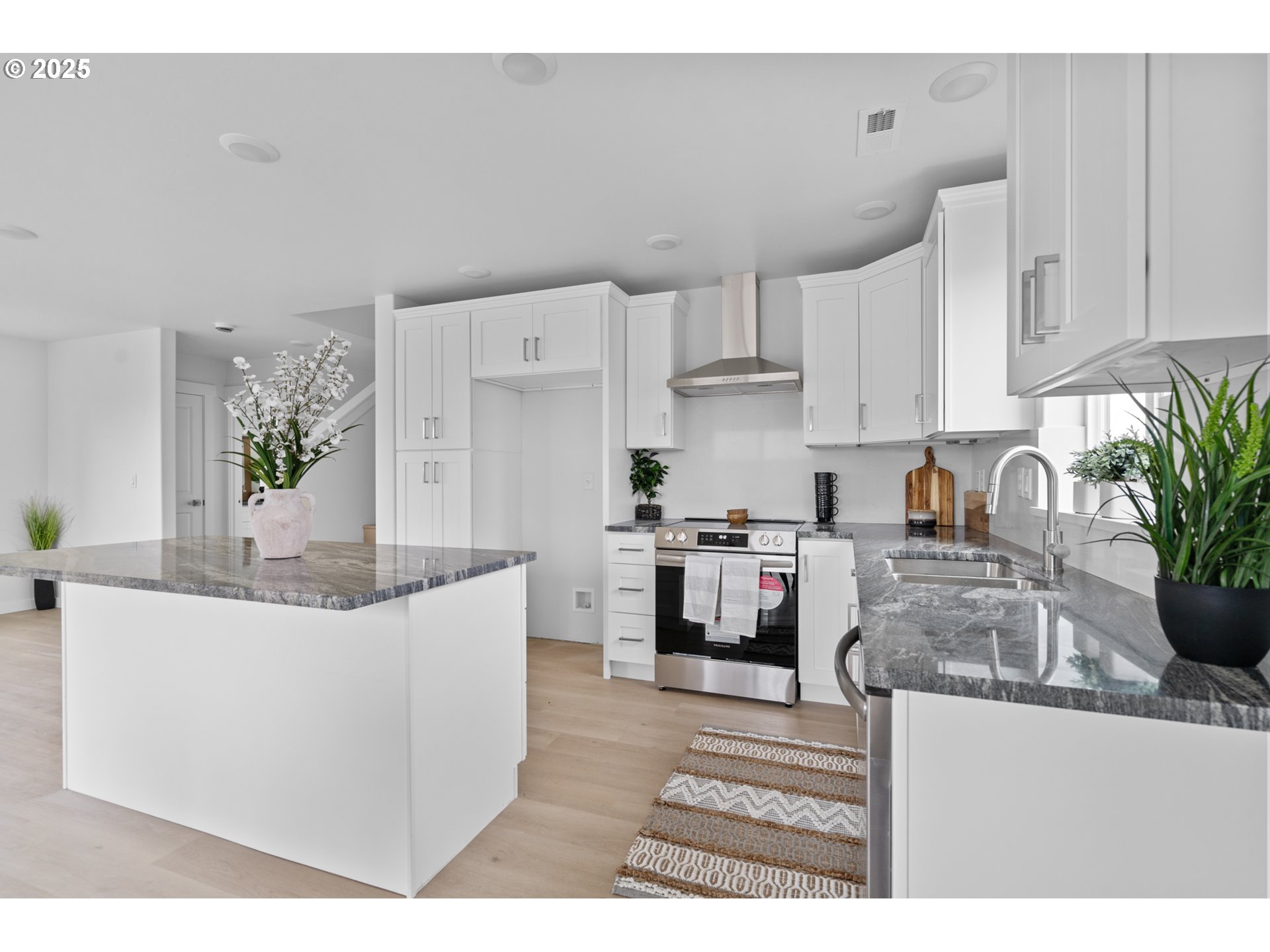 360 Southeast 4th Street Irrigon, OR 97844 - Photo 21 of 36 a kitchen with stainless steel appliances kitchen island granite countertop a sink a stove top oven a counter space and cabinets