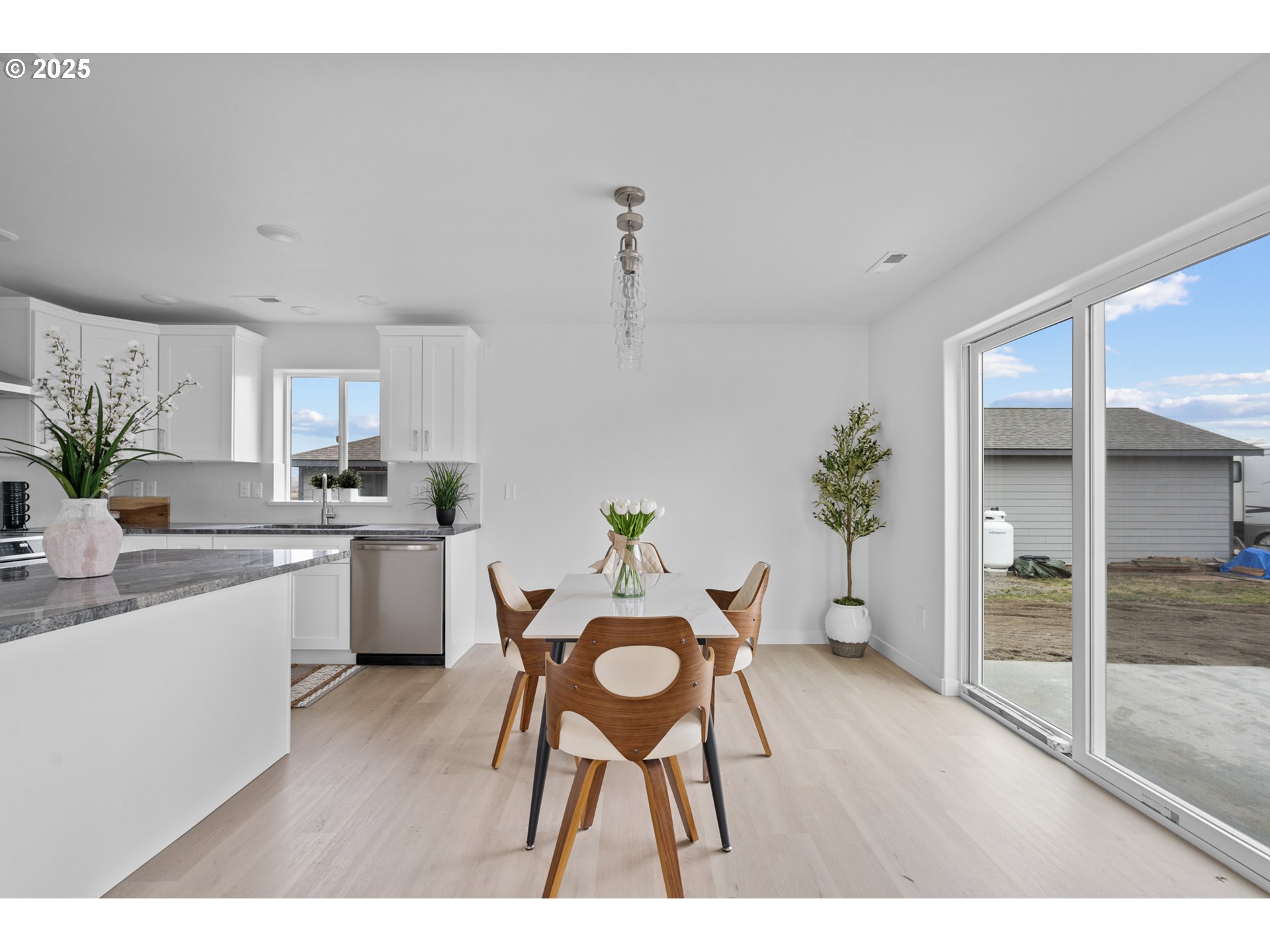 360 Southeast 4th Street Irrigon, OR 97844 - Photo 26 of 36 a open kitchen with granite countertop a sink cabinets and wooden floor
