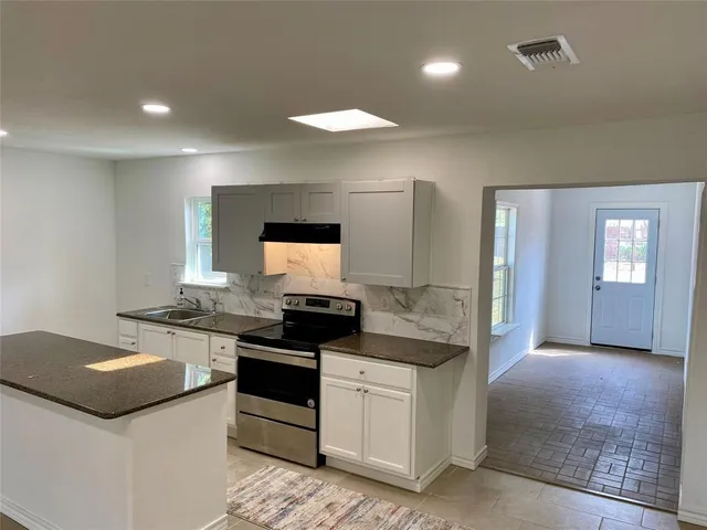 a kitchen with a stove and a sink
