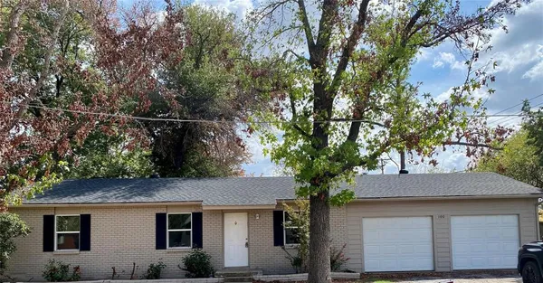 a front view of a house with trees