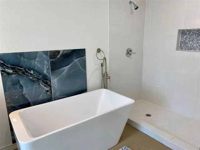 a bathroom with a tub and shower