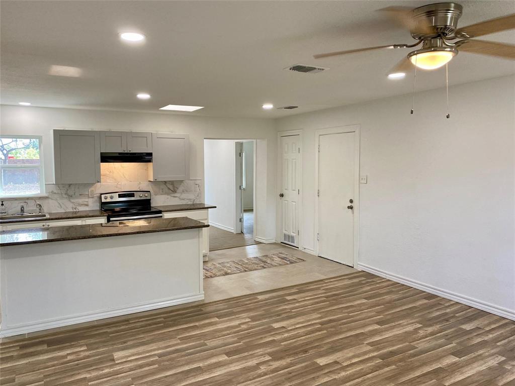 100 Burl Street Corinth, TX 76208 - Photo 5 of 16 a view of a kitchen with a sink and a refrigerator