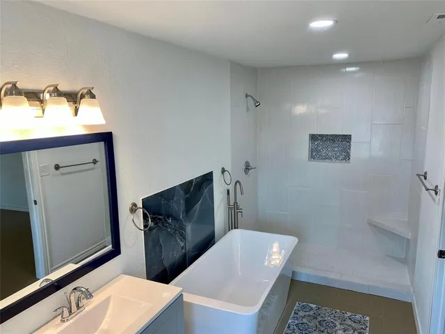 a bathroom with a sink a mirror and a shower