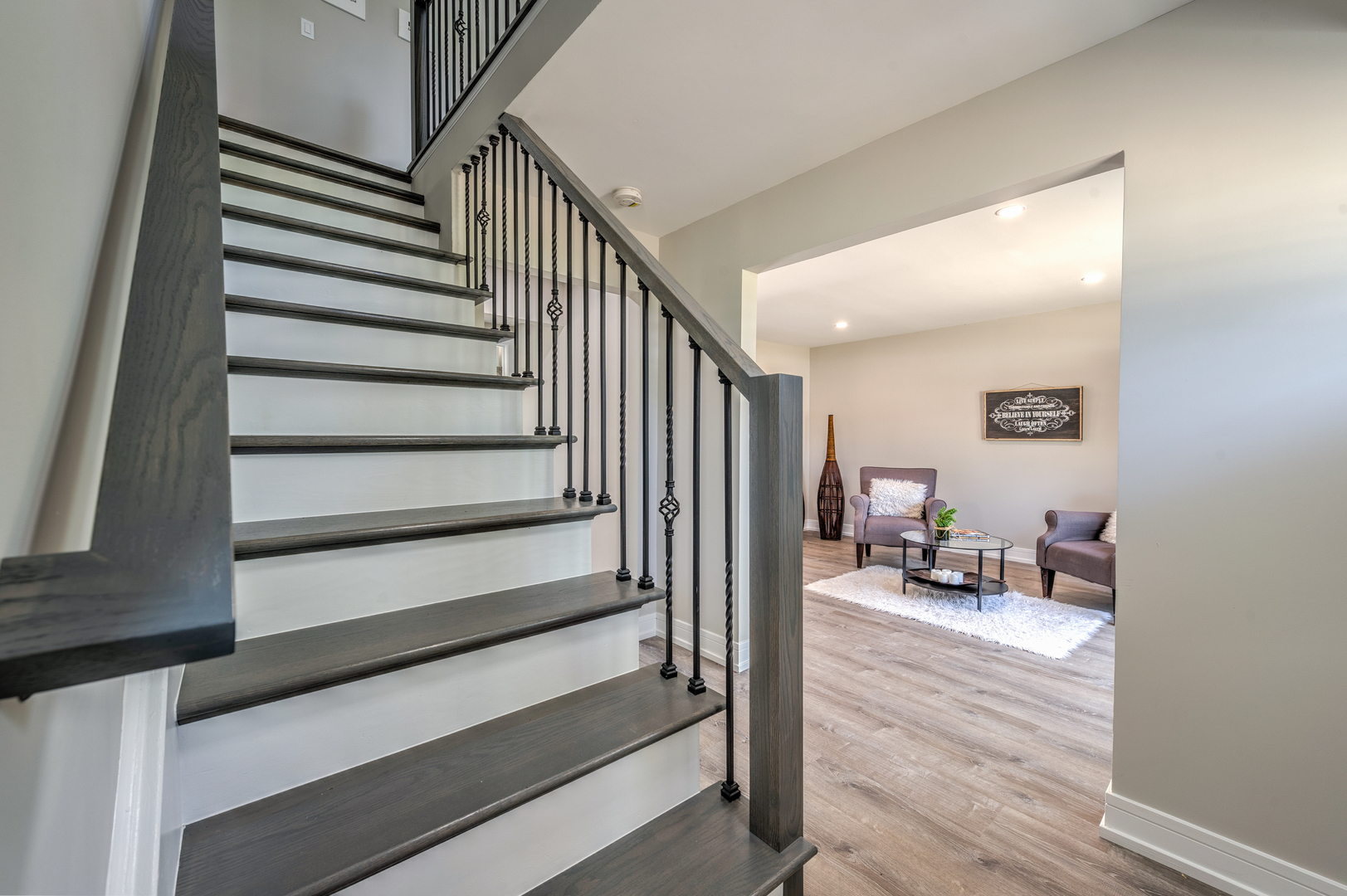 178 Queenswood Road Bolingbrook, IL 60440 - Photo 4 of 26 a view of a hallway to a livingroom with wooden floor and furniture