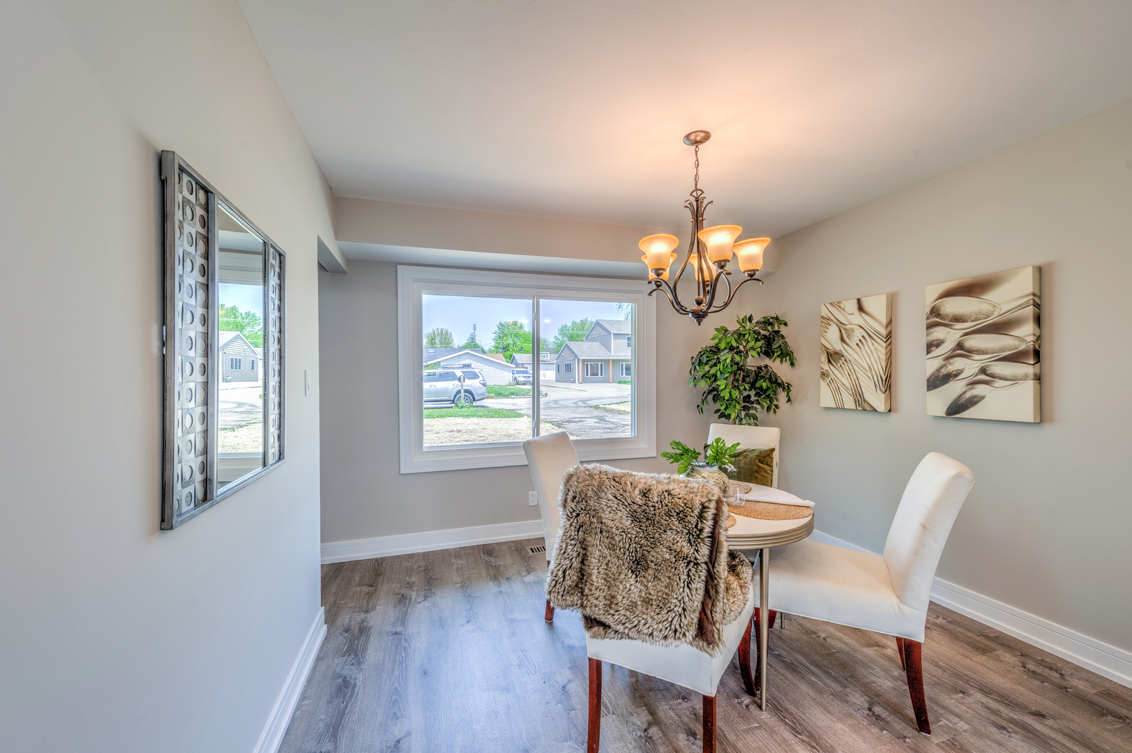 178 Queenswood Road Bolingbrook, IL 60440 - Photo 7 of 26 a dining room with furniture a chandelier and wooden floor