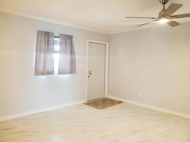a view of a kitchen with a sink and a refrigerator