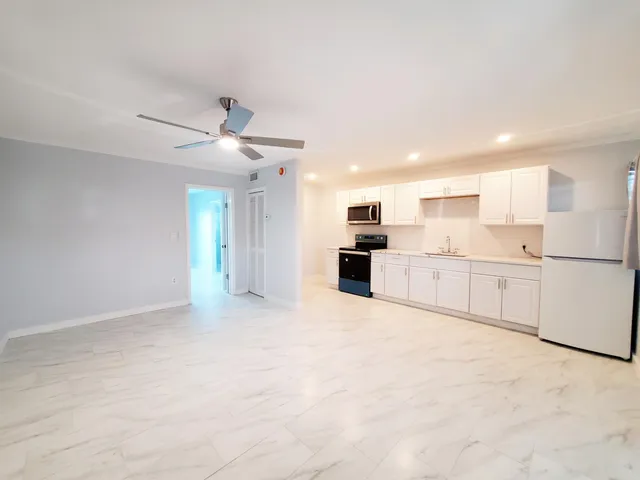 an empty room with closet and windows